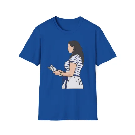 A blue Carlie Irsay-Gordon Shirt featuring an illustration of a woman with long dark hair, wearing a white and blue striped top and white skirt, holding several sheets of paper.