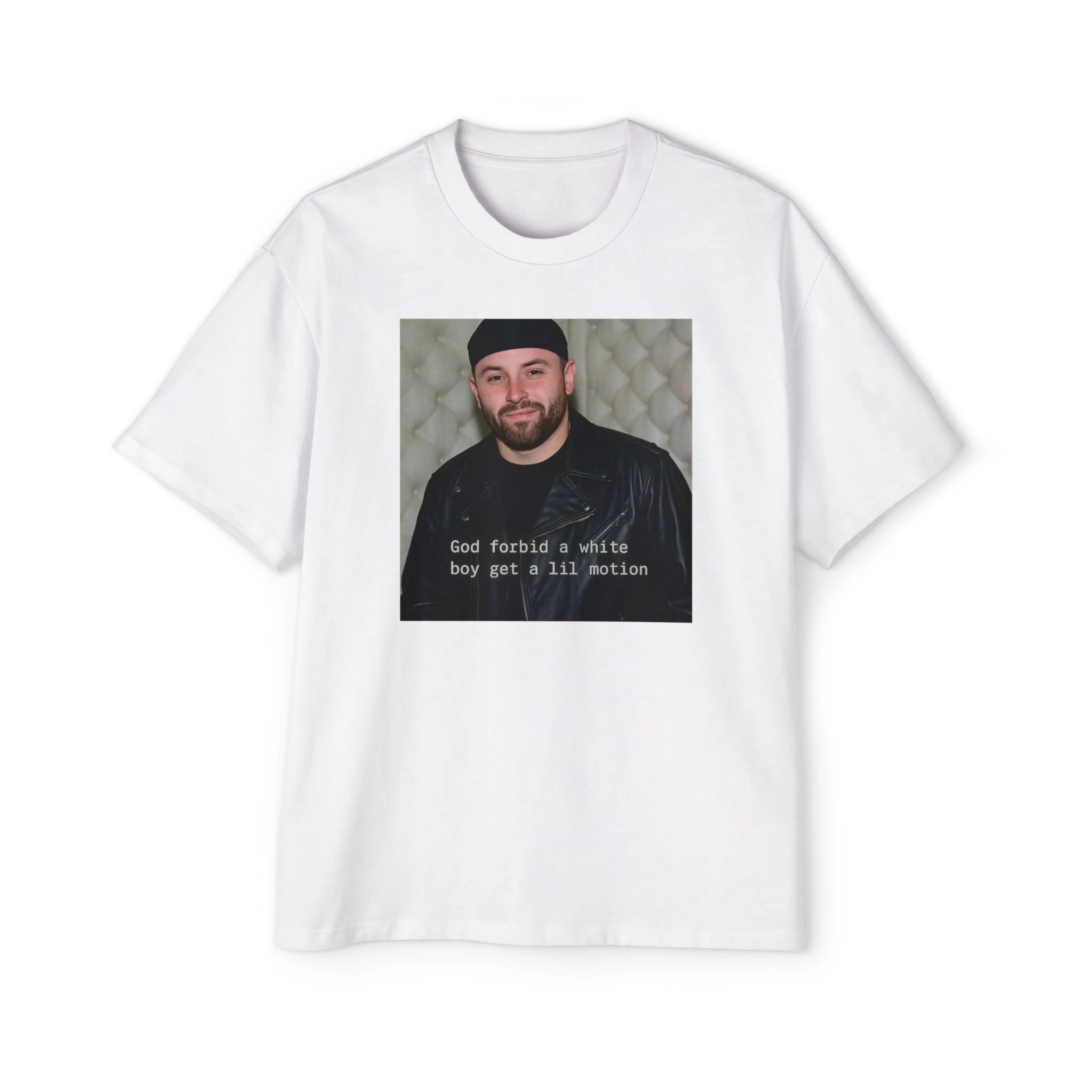 The God Forbid A White Boy Get A Lil Motion Shirt is a white tee featuring a photo of a smiling man in a black jacket and beanie, with the iconic caption printed below the image. The God Forbid A White Boy Get A Lil Motion Shirt is a white tee featuring a photo of a smiling man in a black jacket and beanie, with the iconic caption printed below the image.