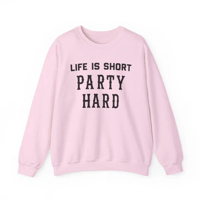 The Life Is Short Party Hard Shirt, in light pink with bold black lettering on the front, is displayed flat against a white background.