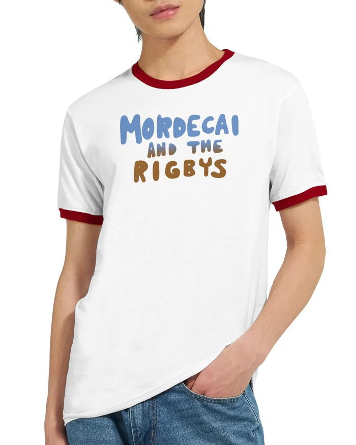 A person wears the Mordecai and the Rigbys Shirt, a white ringer T-shirt with red trim featuring "Mordecai and the Rigbys" printed in blue and brown letters on the front.