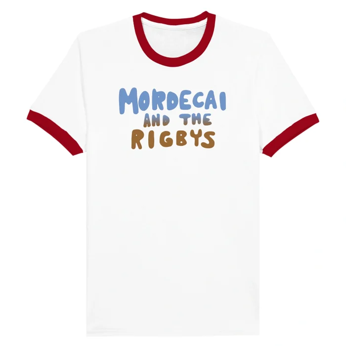The Mordecai and the Rigbys Shirt is a white tee with a red collar and sleeve edges. "MORDECAI AND THE RIGBYS" is printed on the chest in playful blue and brown rounded letters.