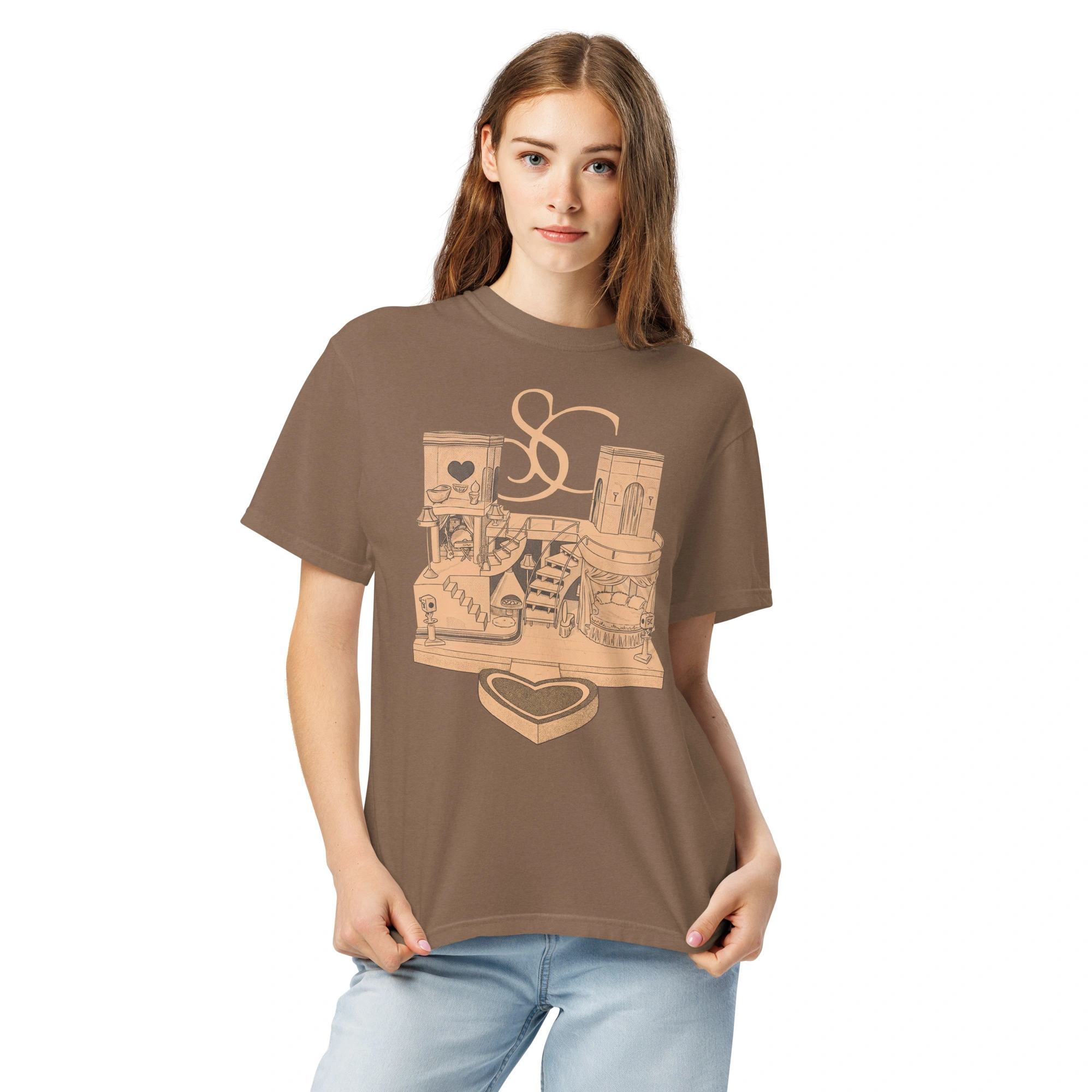 A young woman with long brown hair stands against a white background, wearing the Sabrina Carpenter House Tour Shirt—a brown graphic tee with abstract designs, books, hearts, and the letters S and C—paired with light blue jeans. A young woman with long brown hair stands against a white background, wearing the Sabrina Carpenter House Tour Shirt—a brown graphic tee with abstract designs, books, hearts, and the letters S and C—paired with light blue jeans.