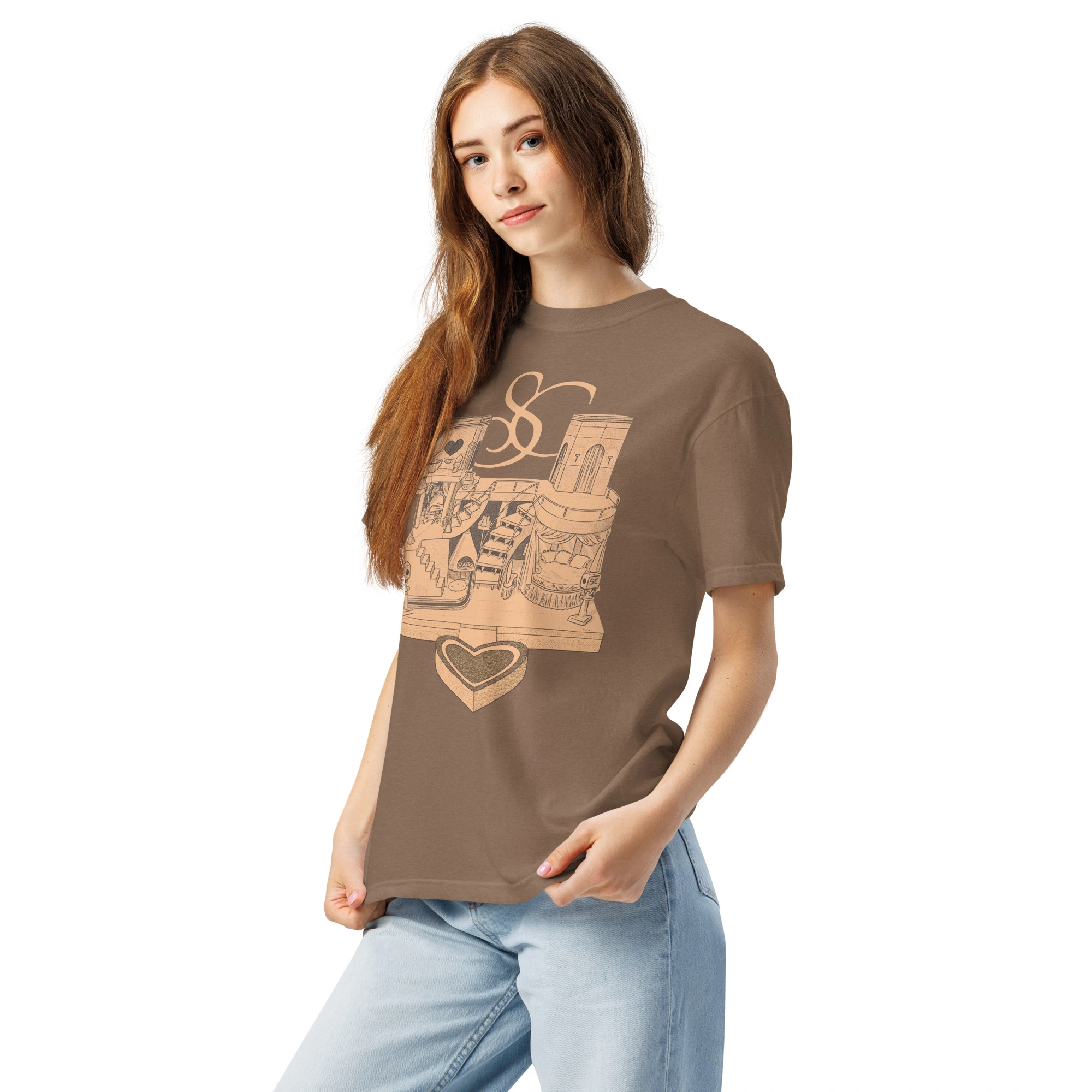 A young woman with long brown hair wears the Sabrina Carpenter House Tour Shirt—featuring tan graphics on brown—paired with light blue jeans, posing with one hand in her pocket against a plain white background. A young woman with long brown hair wears the Sabrina Carpenter House Tour Shirt—featuring tan graphics on brown—paired with light blue jeans, posing with one hand in her pocket against a plain white background.
