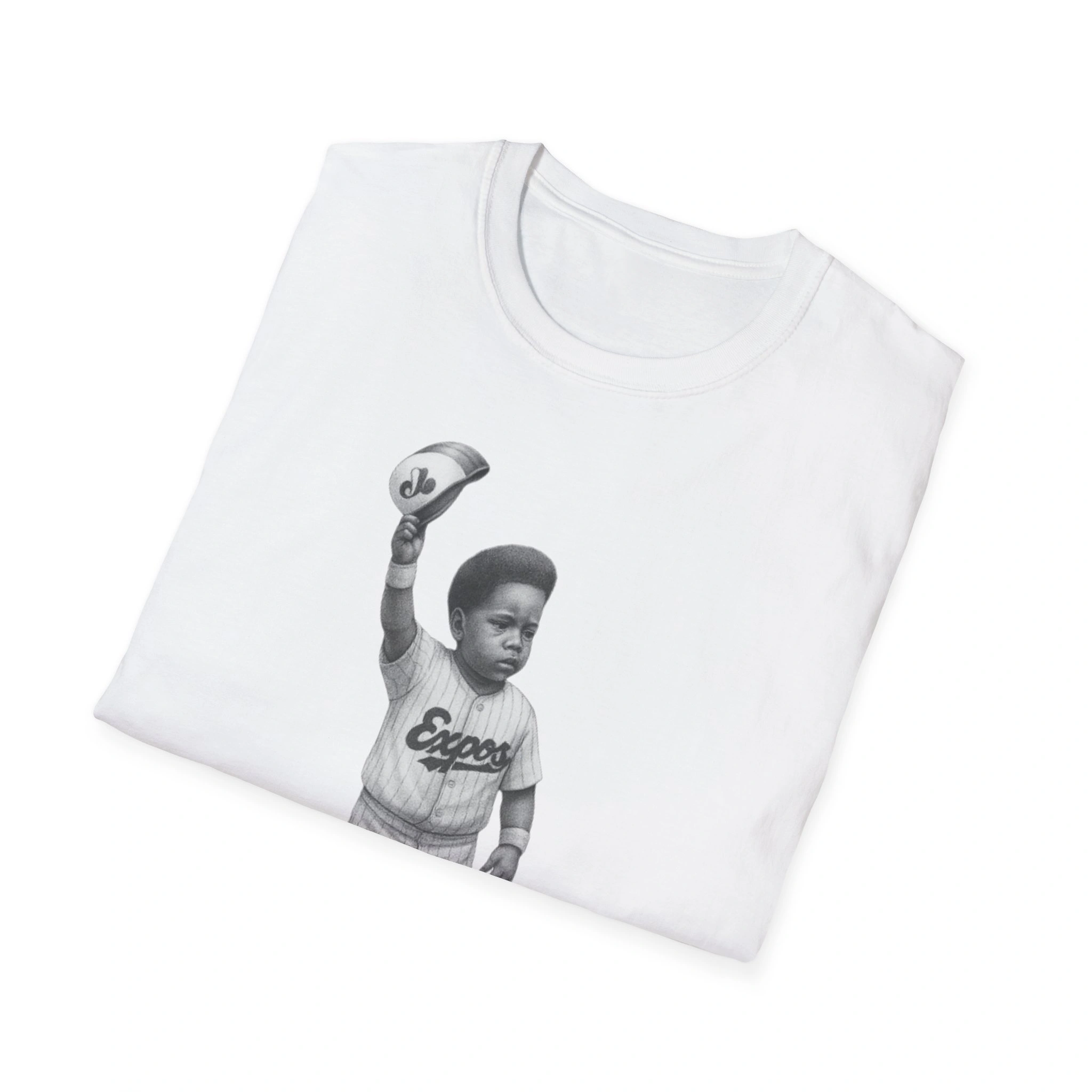 A folded white T-shirt featuring a black and white illustration of a young boy in an Expos uniform raising his capβan inspired Vladimir Guerrero Jr. Born Ready Shirt design. A folded white T-shirt featuring a black and white illustration of a young boy in an Expos uniform raising his capβan inspired Vladimir Guerrero Jr. Born Ready Shirt design.