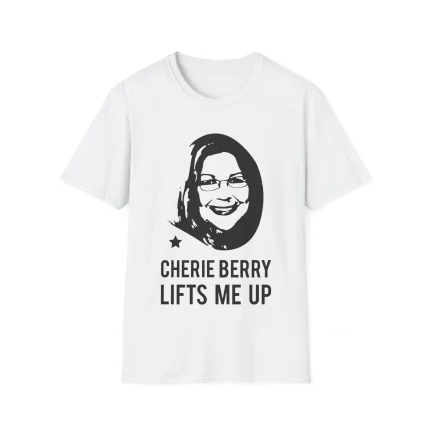 The Cherie Berry Lifts Me Up Shirt is a white tee with a black graphic of a smiling woman with glasses above the words “CHERIE BERRY LIFTS ME UP,” styled like the Bubba Trump x Bill Clinton Shirt, and includes a small star left of the text.