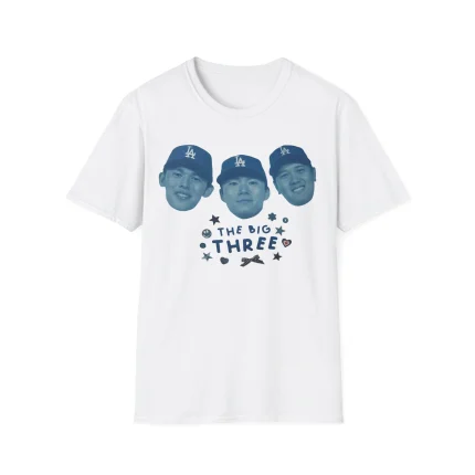 The Dodgers The Big Three Shirt showcases three blue-tinted faces in baseball caps above "THE BIG THREE," surrounded by stars, hearts, and a shoe—an essential for any Dodgers World Series 2025 Shirt collection.