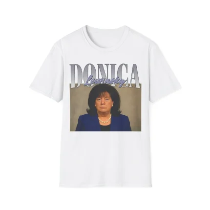 The Donica Lewinsky Shirt features a white tee with a printed image of a person in a navy blazer and pearl necklace, bold DONICA text above, and "Lewinsky" in script—part of the Deport Zohran Shirt collection.